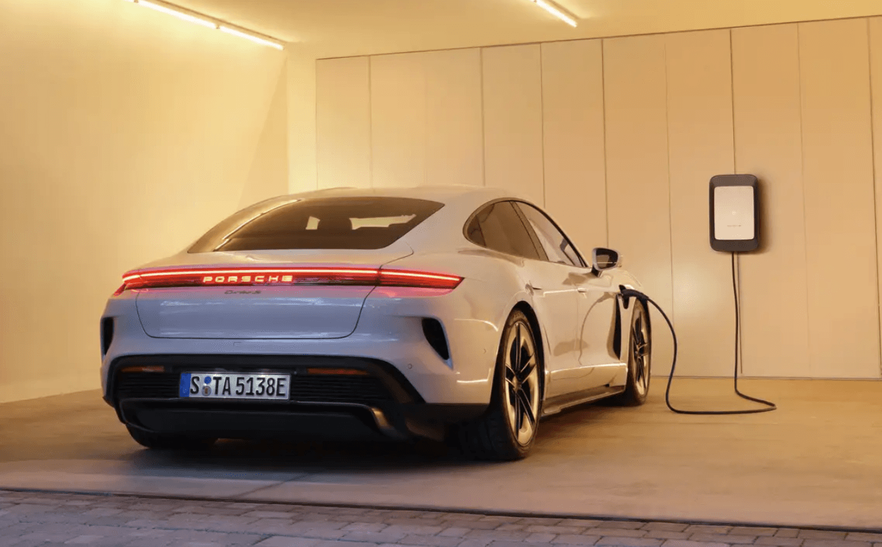 Electric Porsche Model Parked And Charging In A Garage - Feature Image